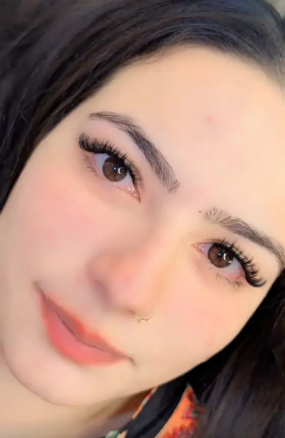 Client with wispy volume lash extensions, eyes open